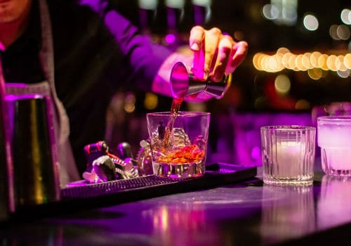 A bartender preparing a cocktail at a stylish bar